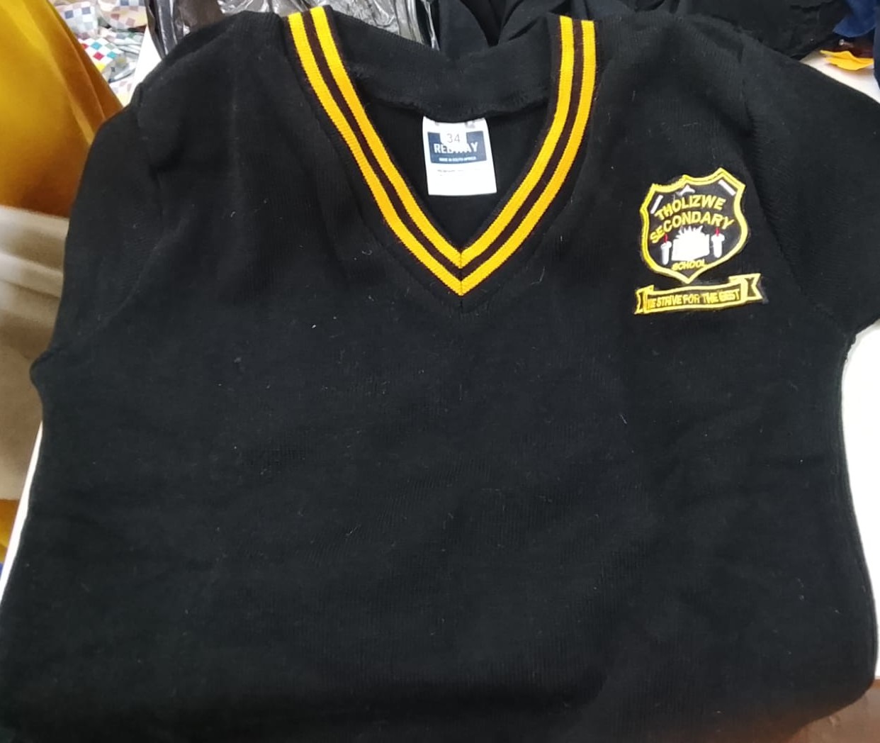 Black V-neck jersey with Tholizwe Secondary School embroidery
